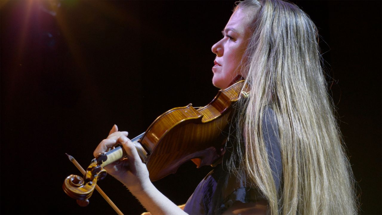 a woman playing violin